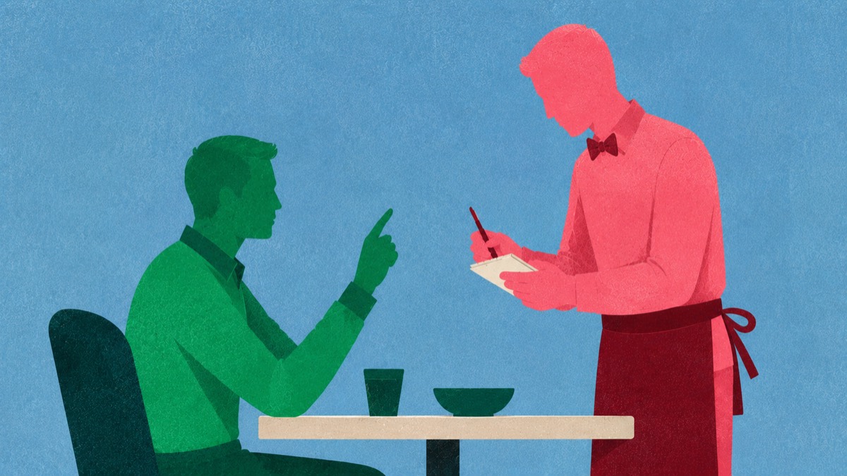 A seated customer giving instructions to a server writing them down